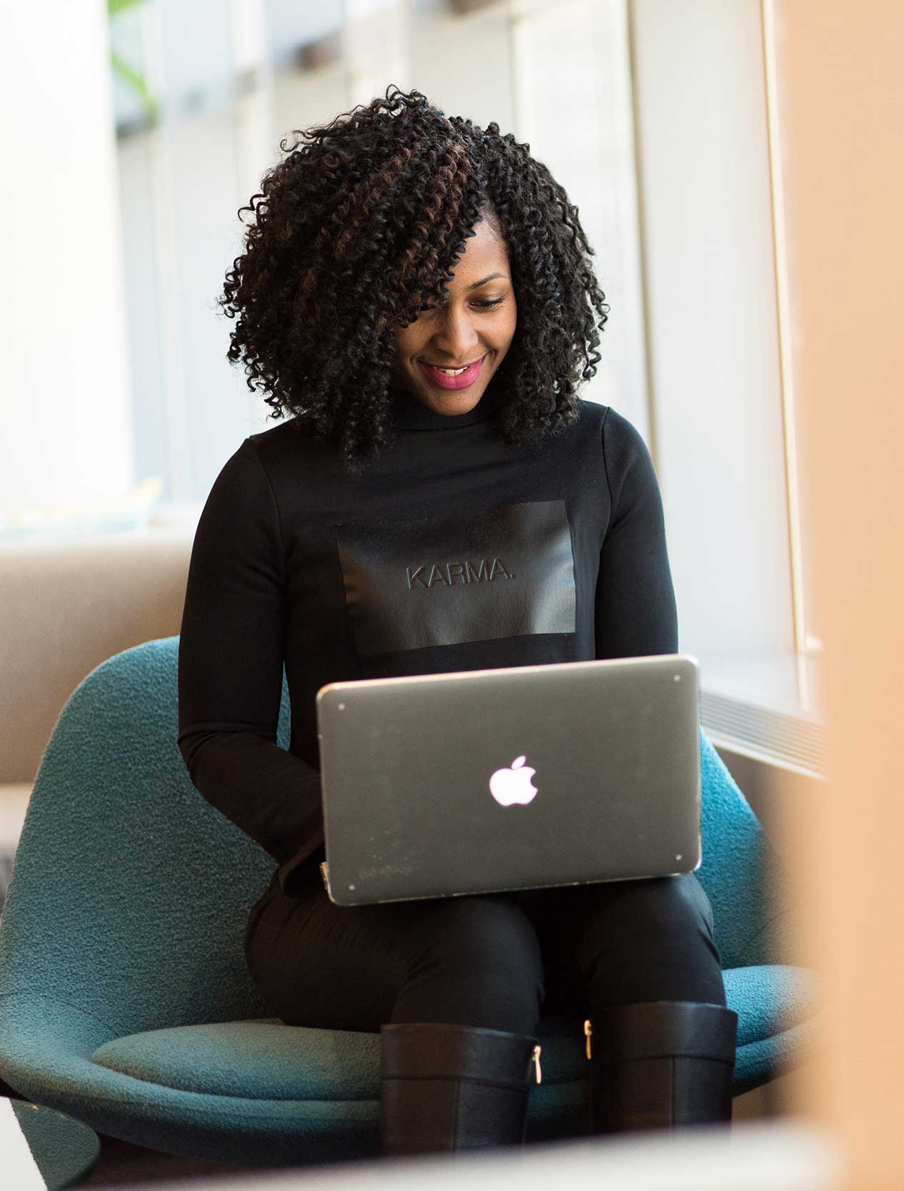 woman sitting down working on her laptop